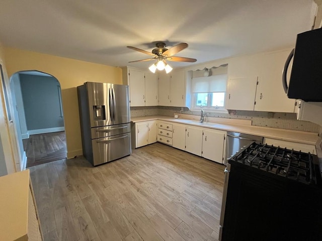 189 Bush St, Fall River, MA 02724 - kitchen with stainless steel fridge with ice dispenser, black microwave, gas range oven, a ceiling fan, and a sink