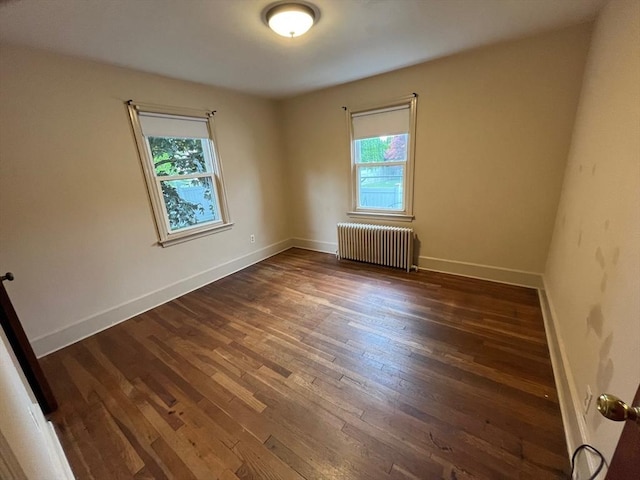 189 Bush St, Fall River, MA 02724 - spare room featuring radiator, plenty of natural light, wood-type flooring, and baseboards