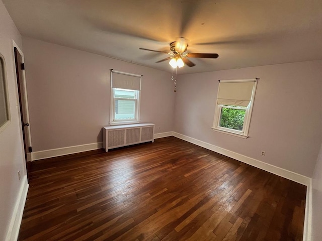 189 Bush St, Fall River, MA 02724 - unfurnished room featuring radiator heating unit, plenty of natural light, and dark wood-style floors