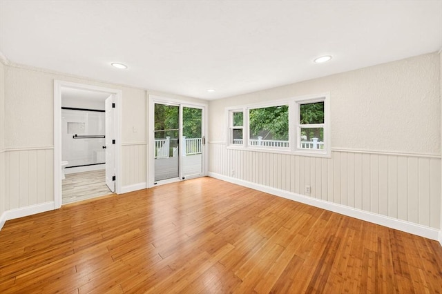 70 Hancock St, Whitman, MA 02382 - unfurnished room with light wood finished floors and wainscoting
