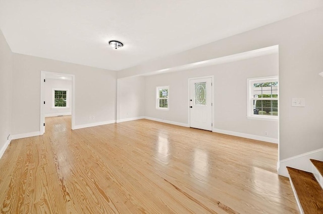 70 Hancock St, Whitman, MA 02382 - unfurnished living room featuring light wood-style floors and stairway