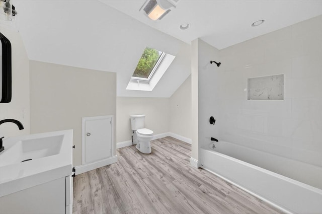 70 Hancock St, Whitman, MA 02382 - bathroom featuring a skylight, shower / bathtub combination, vaulted ceiling, vanity, and wood finished floors