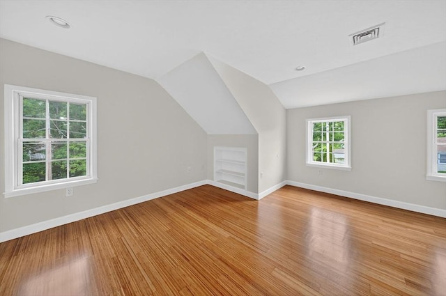 70 Hancock St, Whitman, MA 02382 - additional living space with wood finished floors, built in shelves, and lofted ceiling