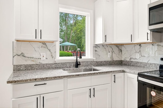 70 Hancock St, Whitman, MA 02382 - kitchen featuring stainless steel appliances, white cabinetry, and plenty of natural light
