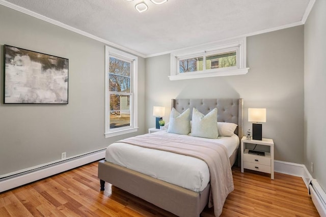 bedroom featuring a baseboard radiator, wood finished floors, and crown molding