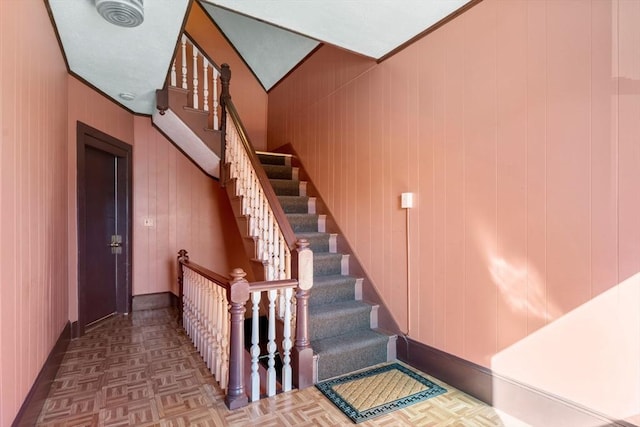 staircase featuring baseboards and ornamental molding