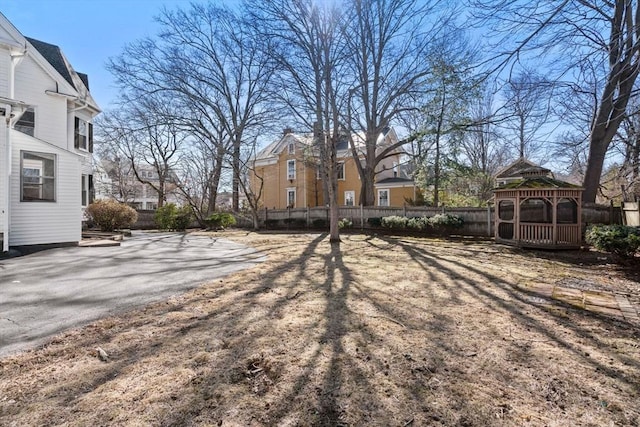 view of yard featuring a gazebo, a residential view, and fence