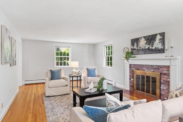 21 Johnson Rd, Winchester, MA 01890 - living room with baseboard heating, light wood-type flooring, a fireplace, and baseboards