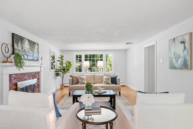 21 Johnson Rd, Winchester, MA 01890 - living room featuring a baseboard heating unit, light wood finished floors, and baseboards