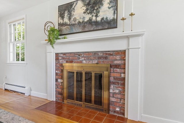 21 Johnson Rd, Winchester, MA 01890 - detailed view of a baseboard heating unit, a fireplace, wood finished floors, and baseboards