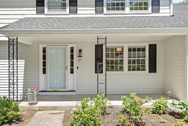 21 Johnson Rd, Winchester, MA 01890 - property entrance with roof with shingles and covered porch