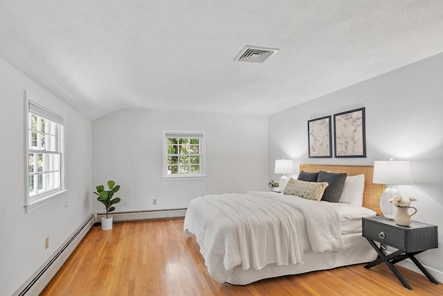 21 Johnson Rd, Winchester, MA 01890 - bedroom with a baseboard radiator, multiple windows, light wood finished floors, vaulted ceiling, and baseboards