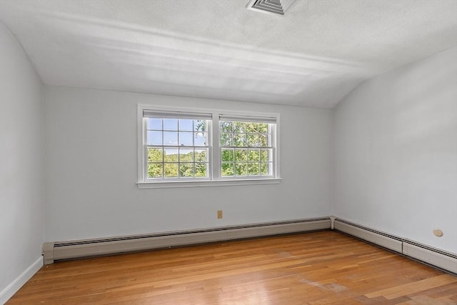 21 Johnson Rd, Winchester, MA 01890 - spare room with vaulted ceiling, light wood-type flooring, and a baseboard radiator