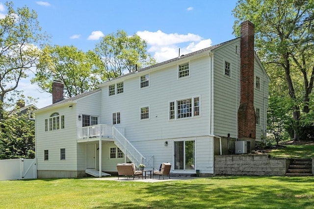 21 Johnson Rd, Winchester, MA 01890 - rear view of house featuring a chimney, stairway, a gate, and a patio