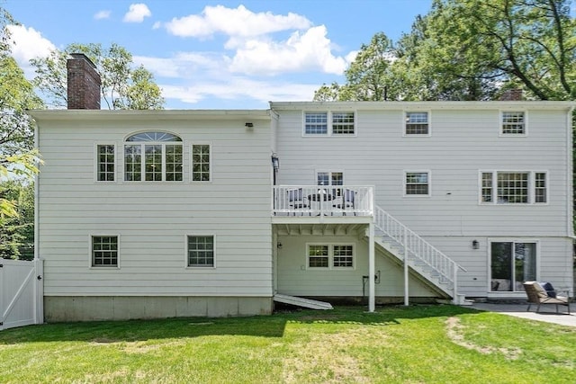 21 Johnson Rd, Winchester, MA 01890 - rear view of house with a chimney, a wooden deck, a patio area, and stairs