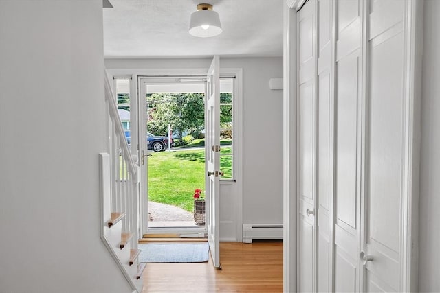 21 Johnson Rd, Winchester, MA 01890 - foyer featuring a baseboard heating unit, stairway, and light wood finished floors