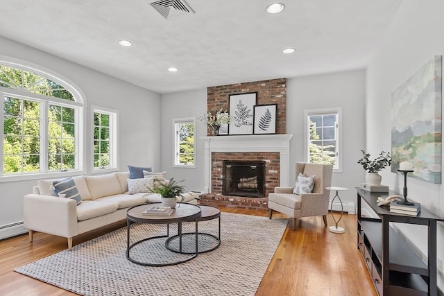 21 Johnson Rd, Winchester, MA 01890 - living room with baseboard heating, wood finished floors, a fireplace, and recessed lighting