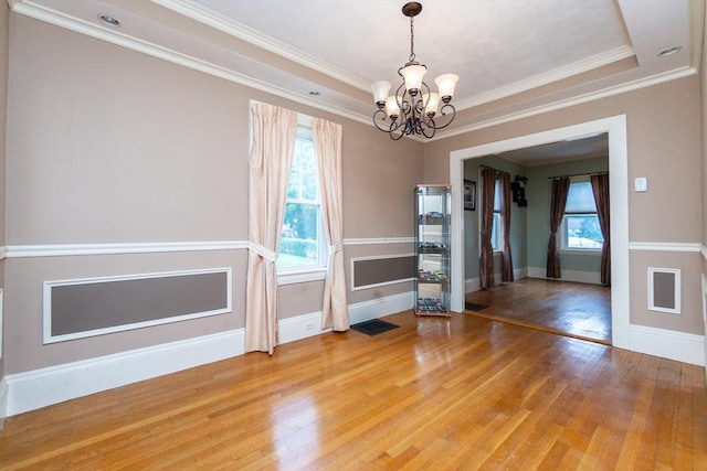 13 Mullin Ave, Quincy, MA 02169 - unfurnished room with a chandelier, light wood finished floors, ornamental molding, and a raised ceiling