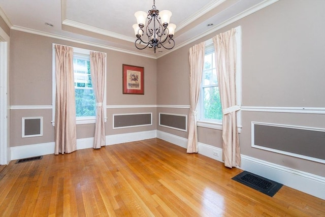 13 Mullin Ave, Quincy, MA 02169 - unfurnished dining area featuring a chandelier, light wood-style floors, a raised ceiling, and ornamental molding