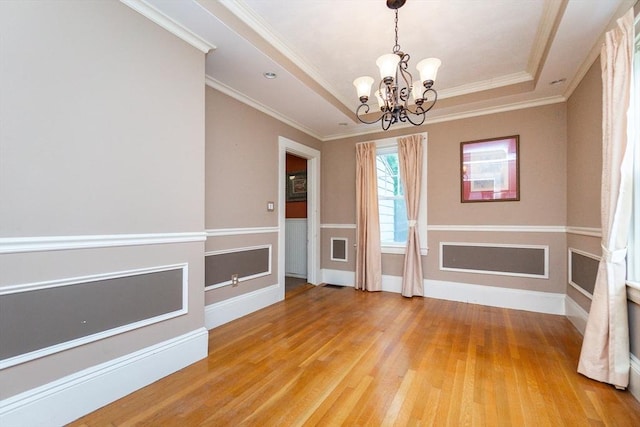 13 Mullin Ave, Quincy, MA 02169 - spare room featuring a chandelier, light wood finished floors, a tray ceiling, and ornamental molding