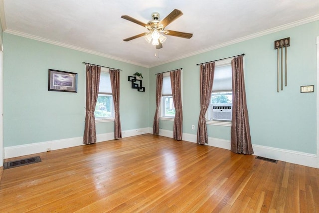 13 Mullin Ave, Quincy, MA 02169 - spare room with a ceiling fan, healthy amount of natural light, light wood finished floors, ornamental molding, and cooling unit