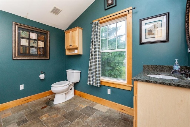 13 Mullin Ave, Quincy, MA 02169 - bathroom with vaulted ceiling, vanity, and stone finish floors