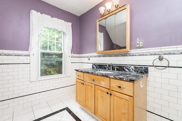 13 Mullin Ave, Quincy, MA 02169 - bathroom with tile walls, a wainscoted wall, tile patterned floors, vanity, and inlaid floor details