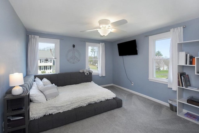 carpeted bedroom featuring a ceiling fan and baseboards