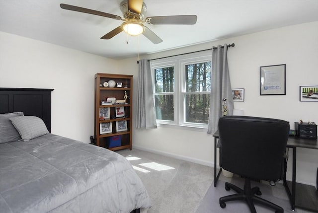 carpeted bedroom with baseboards and ceiling fan