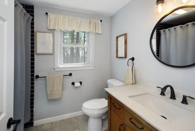 full bath featuring vanity, baseboards, tile patterned floors, and toilet