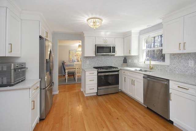 kitchen featuring stainless steel appliances, tasteful backsplash, a sink, and a toaster
