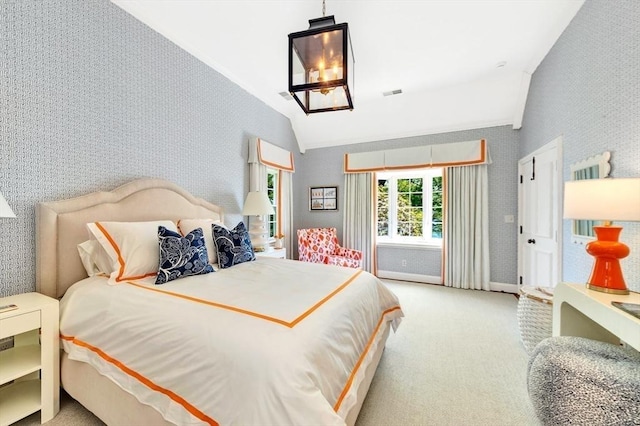 carpeted bedroom featuring lofted ceiling