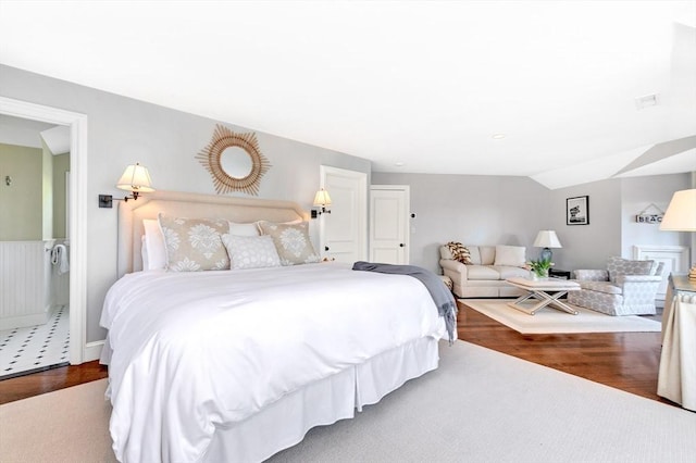 bedroom featuring hardwood / wood-style floors and lofted ceiling