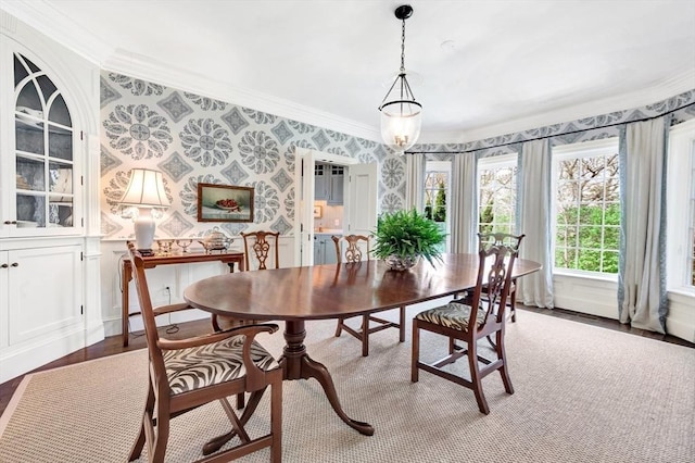 dining space with crown molding and wood-type flooring