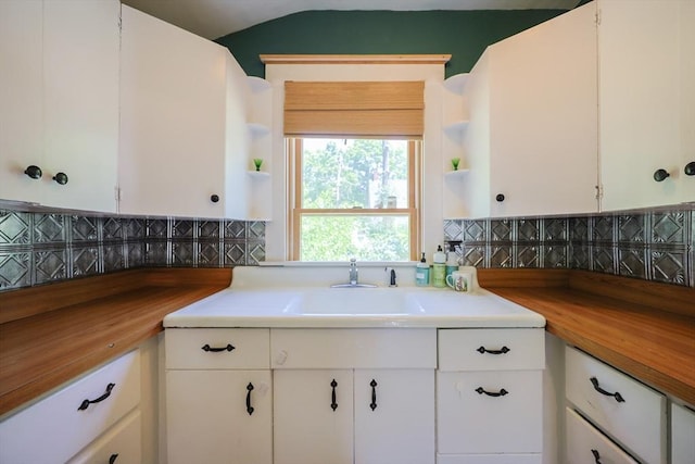 5 Pleasant St, Bourne, MA 02532 - kitchen with open shelves, white cabinetry, and butcher block counters