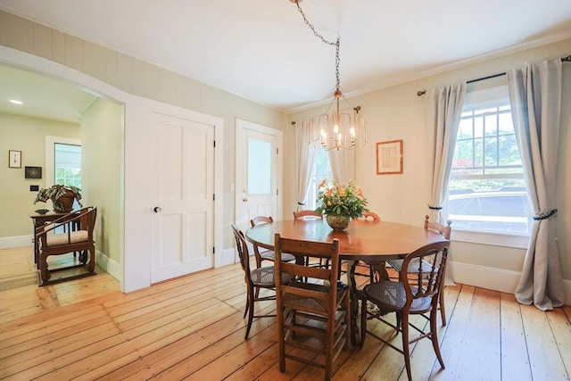 5 Pleasant St, Bourne, MA 02532 - dining area with a chandelier, light wood-style floors, and crown molding