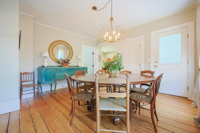 5 Pleasant St, Bourne, MA 02532 - dining room featuring light wood-style floors, ornamental molding, a chandelier, and arched walkways