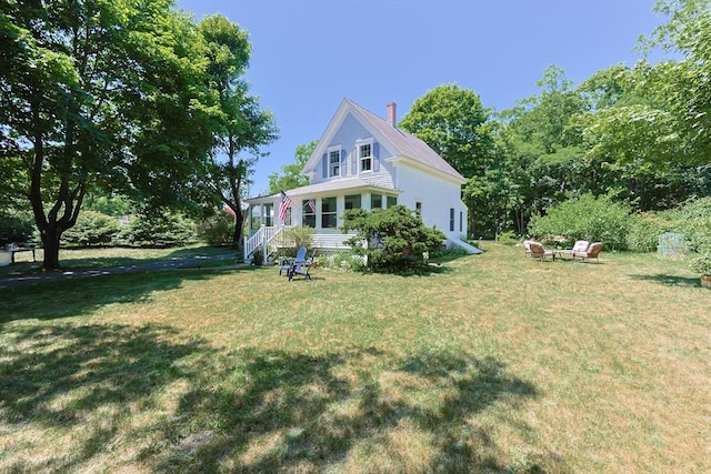 5 Pleasant St, Bourne, MA 02532 - view of property exterior featuring a yard and a chimney