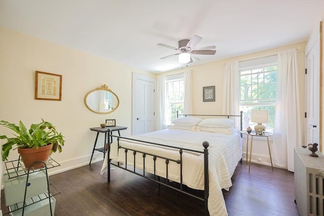 5 Pleasant St, Bourne, MA 02532 - bedroom with multiple windows, dark wood-style flooring, radiator heating unit, and ceiling fan