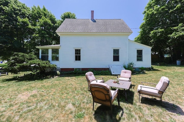 5 Pleasant St, Bourne, MA 02532 - rear view of house with a lawn and a chimney