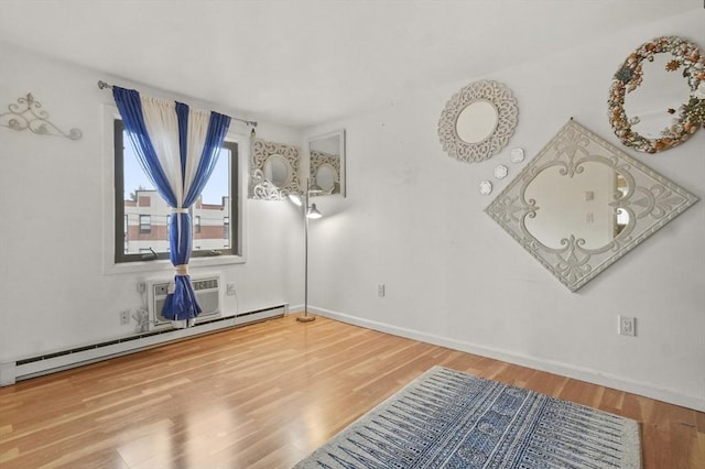 29 Vine St Unit 8, Winchester, MA 01890 - empty room featuring wood finished floors and a baseboard heating unit