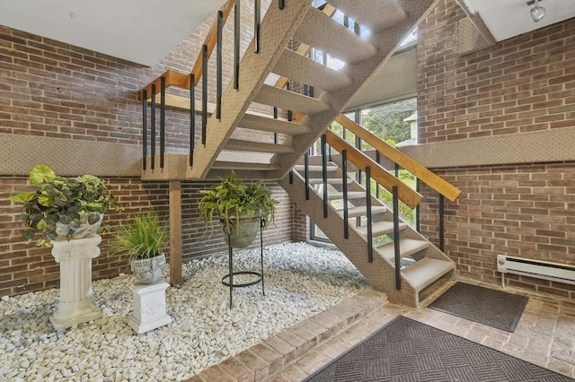 29 Vine St Unit 8, Winchester, MA 01890 - stairway featuring brick wall, a high ceiling, and a baseboard heating unit