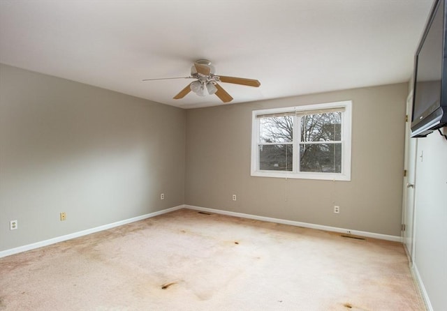 empty room featuring light carpet and ceiling fan