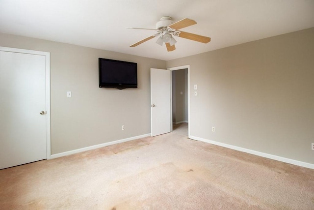 unfurnished bedroom featuring ceiling fan and light colored carpet