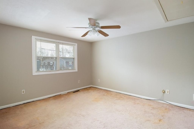 carpeted spare room with ceiling fan