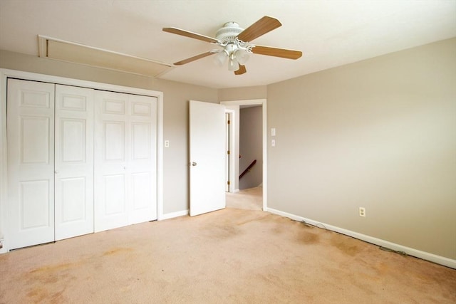 unfurnished bedroom featuring light carpet, ceiling fan, and a closet