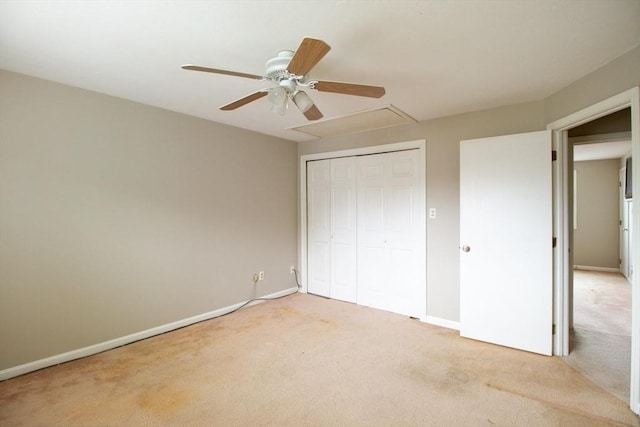 unfurnished bedroom with ceiling fan, light colored carpet, and a closet