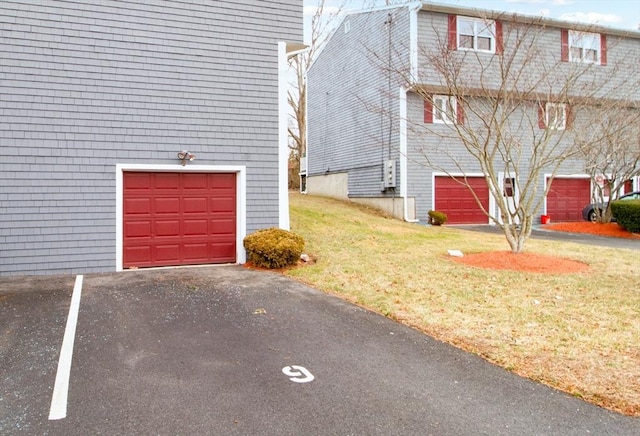 view of side of property featuring a lawn and a garage