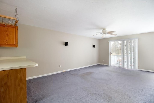 interior space with ceiling fan and dark colored carpet