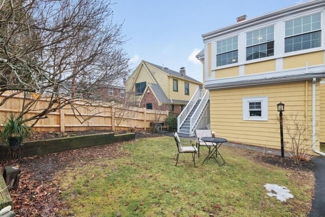 view of yard featuring stairway and fence